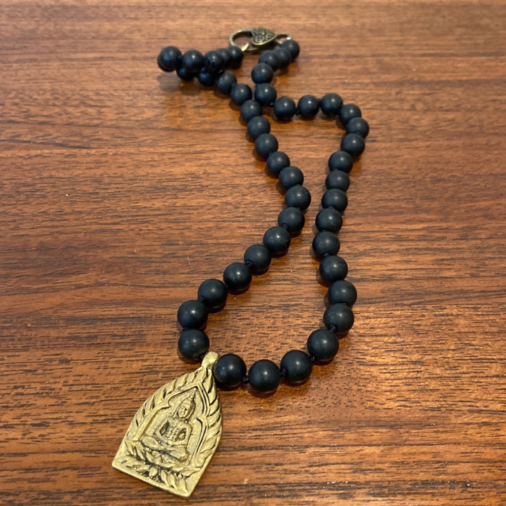 Stone bead necklace with brass eastern charm